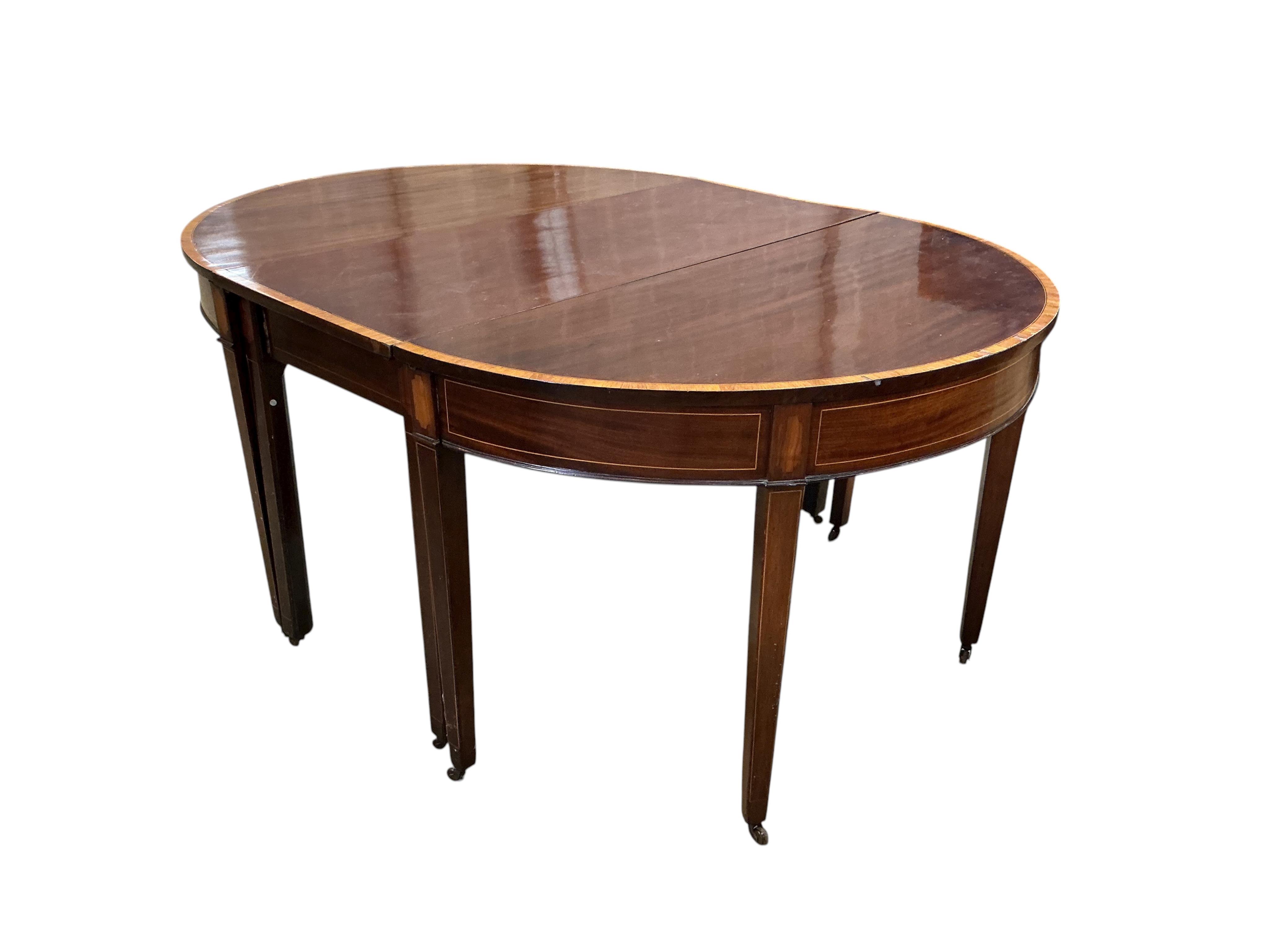 A George III satinwood banded mahogany D end extending dining table, with two spare leaves, 284cm extended, depth 120cm, height 74cm, together with a set of eight Victorian mahogany balloon back dining chairs